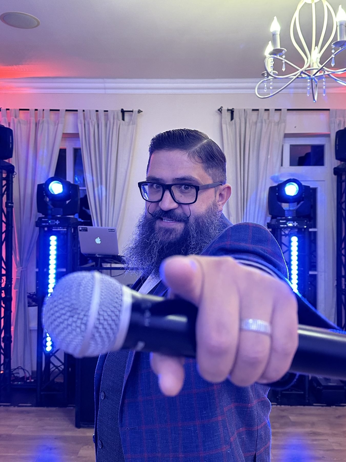 Event host Andrius Vosylius with a microphone at an event