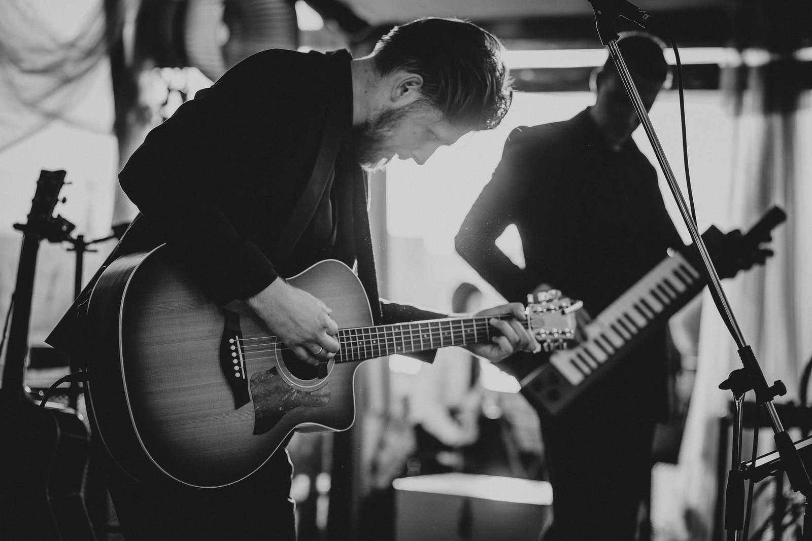 Justinas Stanislovaitis and the band in concert, black and white