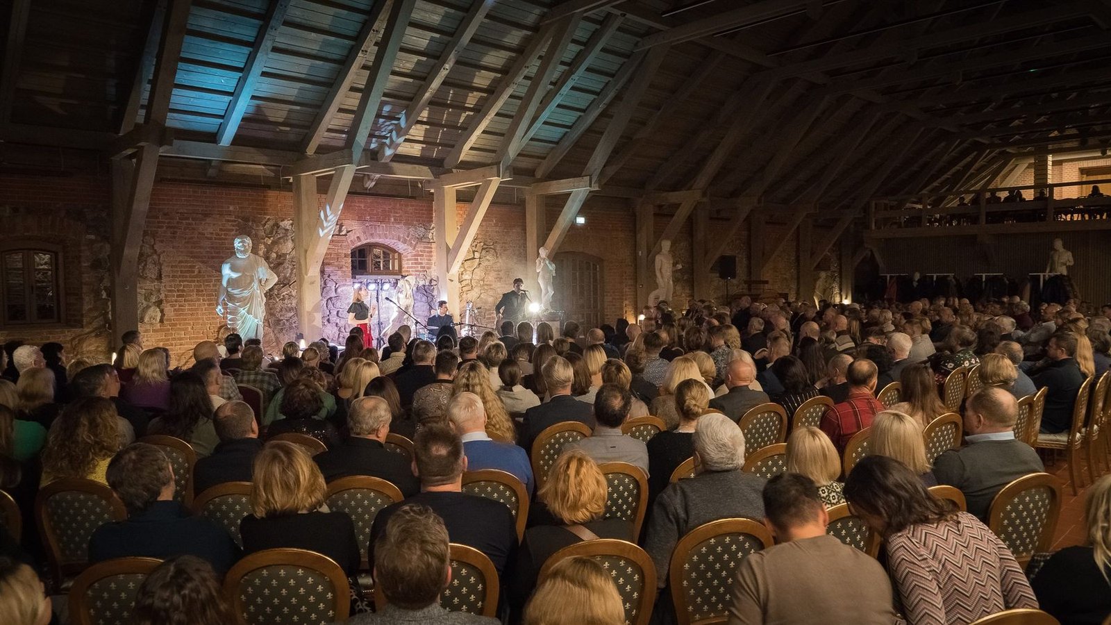Guests filling a manor hall at a celebration