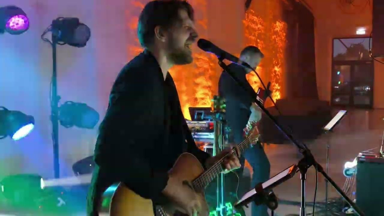 Justinas Stanislovaitis & Band performing under blue stage lights